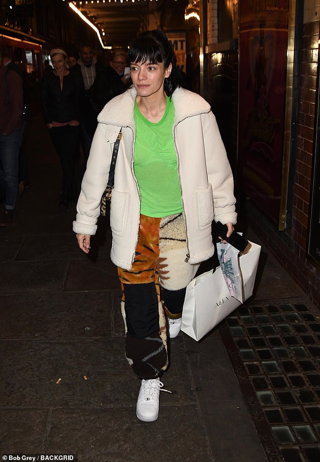 Lily Allen catches the eye in neon top and clashing-print trousers