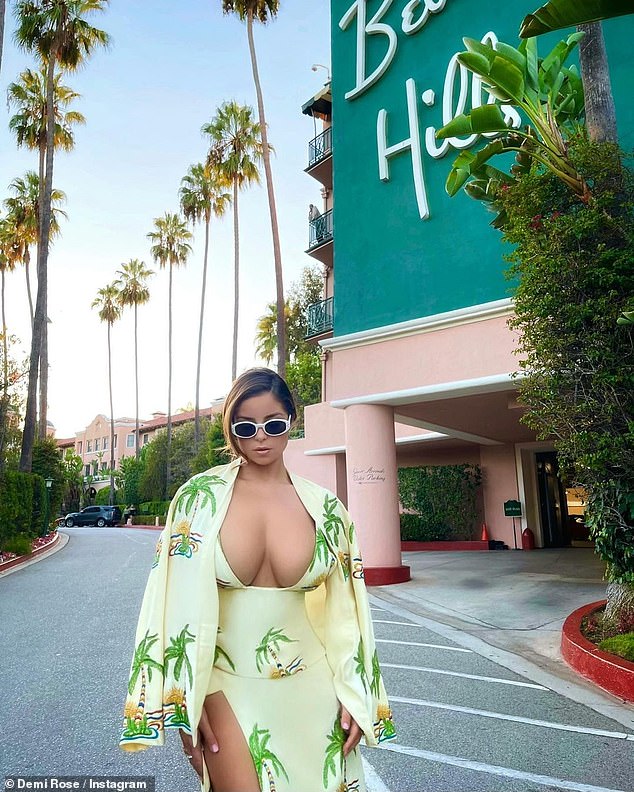 Demi Rose flashes her ample assets in a plunging green dress as she marks her arrival in LA