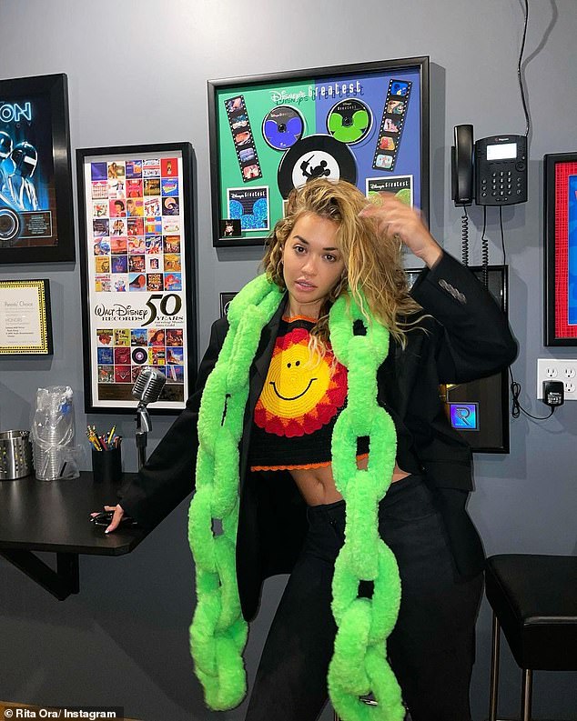 Rita Ora shows off her sense of style in a quirky neon green chain scarf in LA 1