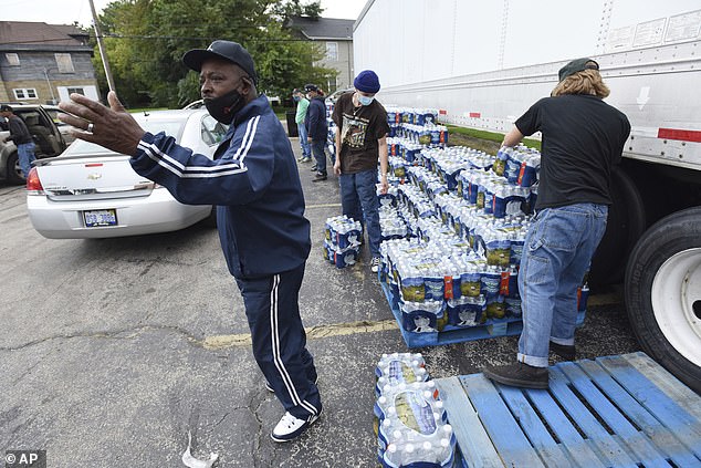 Michigan city is GRIDLOCKED by residents rushing to get free bottled water as lead contaminates tap