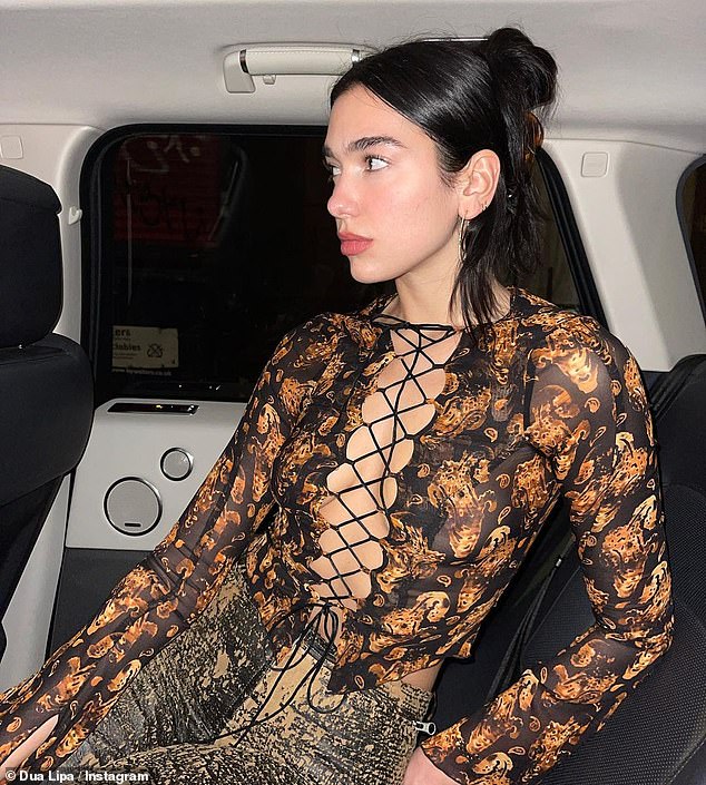Dua Lipa turns up the heat as she flaunts her cleavage in a racy tie-up top and vinyl trousers