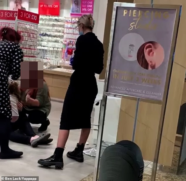 Shocking video shows young girl screaming ‘get off’ as she is held down so her ears can be pierced