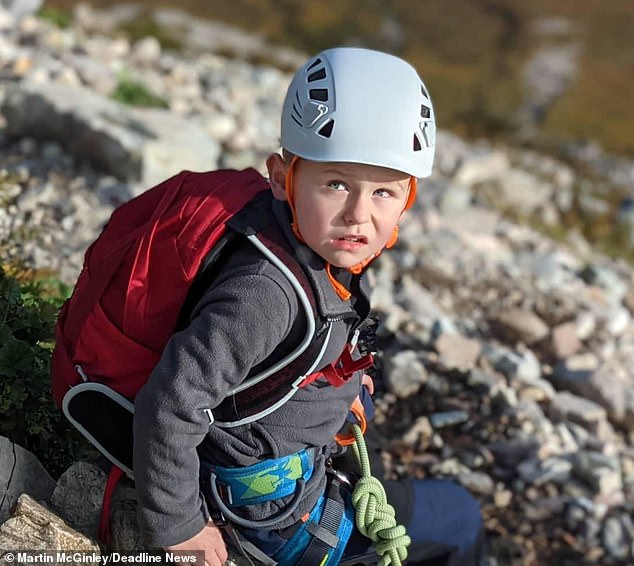 High, dad! Moment seven-year-old boy joins his father as they scale 3,349ft Scottish Munro