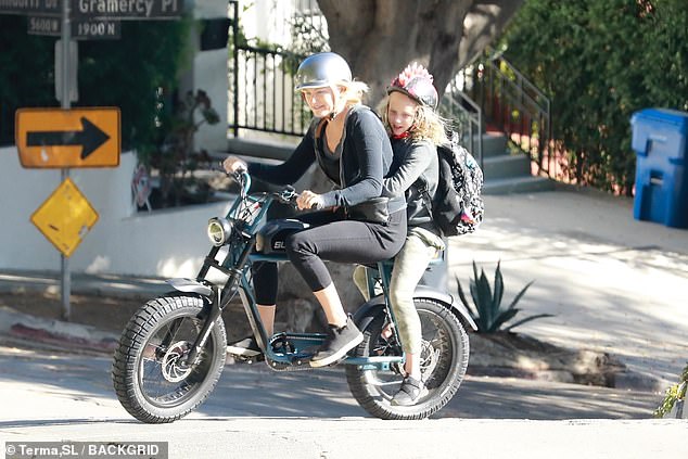 Malin Akerman takes a spin with her son Sebastian on her electric bike