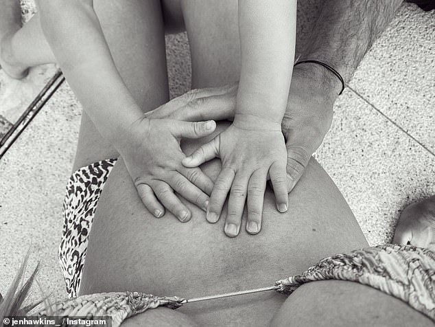 Pregnant Jennifer Hawkins shows off her growing baby bump in a bikini