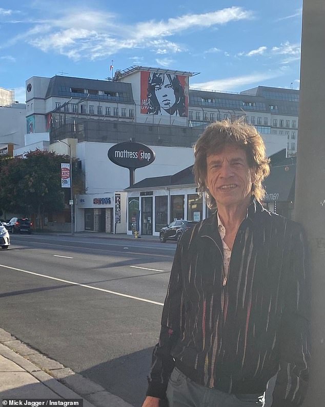Mick Jagger poses in front of a mural of HIMSELF as he enjoys a tourist day out in Los Angeles