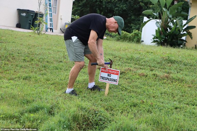 Chris Laundrie hammers ‘no trespassing’ sign into lawn after police confirmed remains belong to son