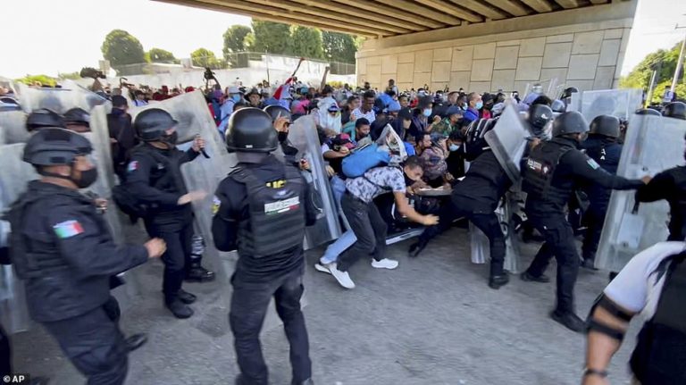 Caravan of 3,000 migrants push past Mexican police as they storm towards the US border