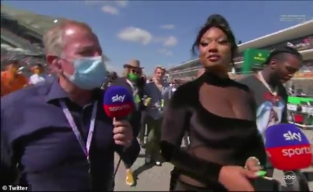 Megan Thee Stallion's entourage step between rapper and F1 legend Martin Brundle during interview 1