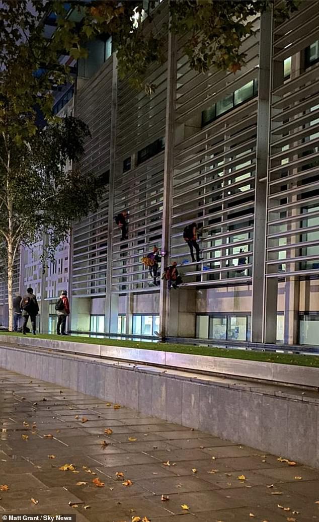 Animal rights activists climb Home Office and Defra building in London