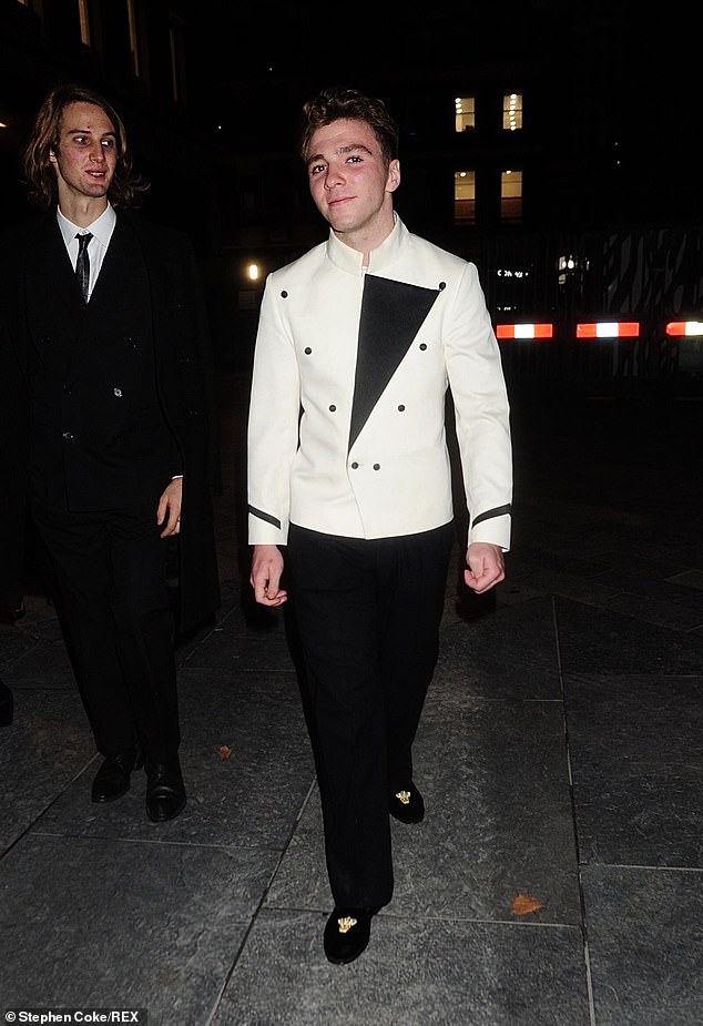 Rocco Ritchie cuts a dapper figure in a white double-breasted jacket for night out in Mayfair
