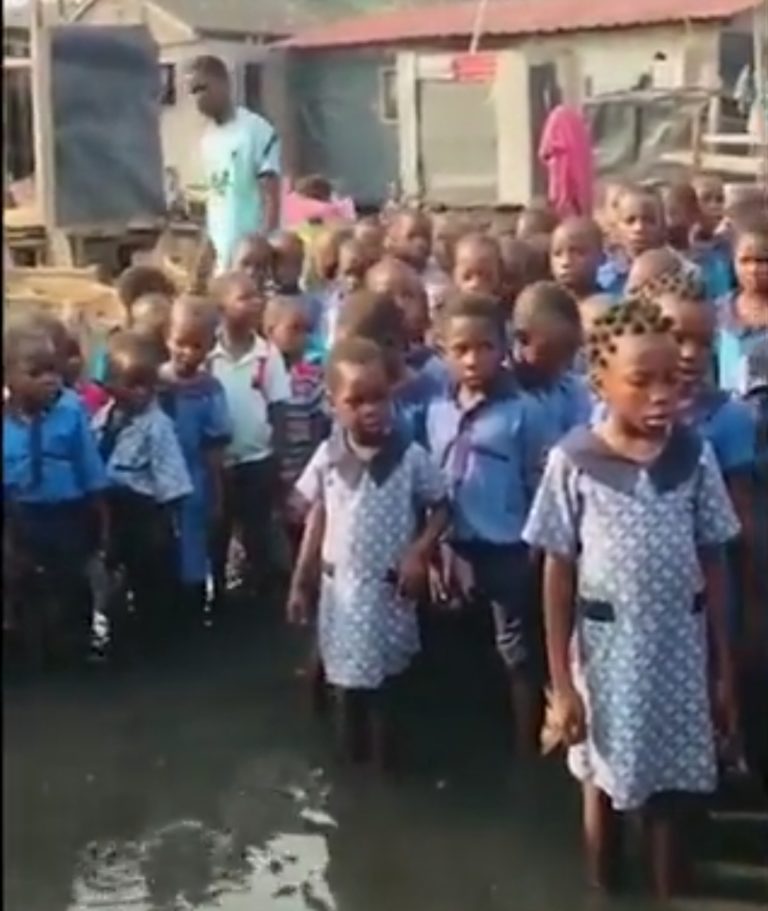 Watch: Lagos primary school kids recite National Anthem inside muddy water in Makoko! Video