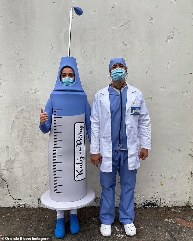Orlando Bloom and Katy Perry pose as a doctor and giant Covid-19 vaccine for Halloween