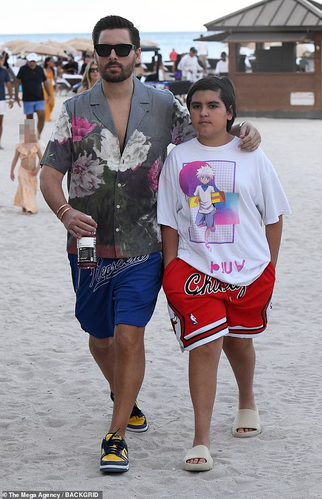 Scott Disick enjoys day of fun in the sun on the beach with son Mason and on ocean in speed boat