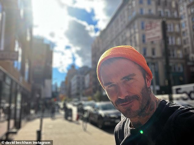David Beckham looks typically handsome as he poses for smouldering selfie after touching down in NYC