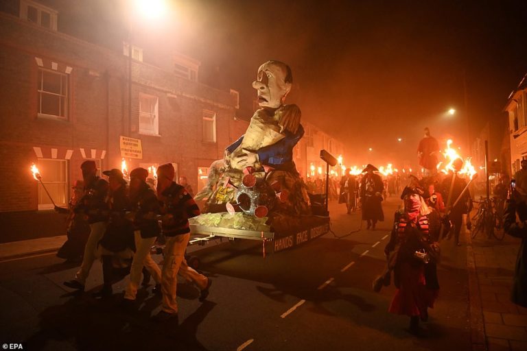 Giant effigy of Guy Fawkes in a face mask with vaccine needles in his arms set to be burned in Lewes