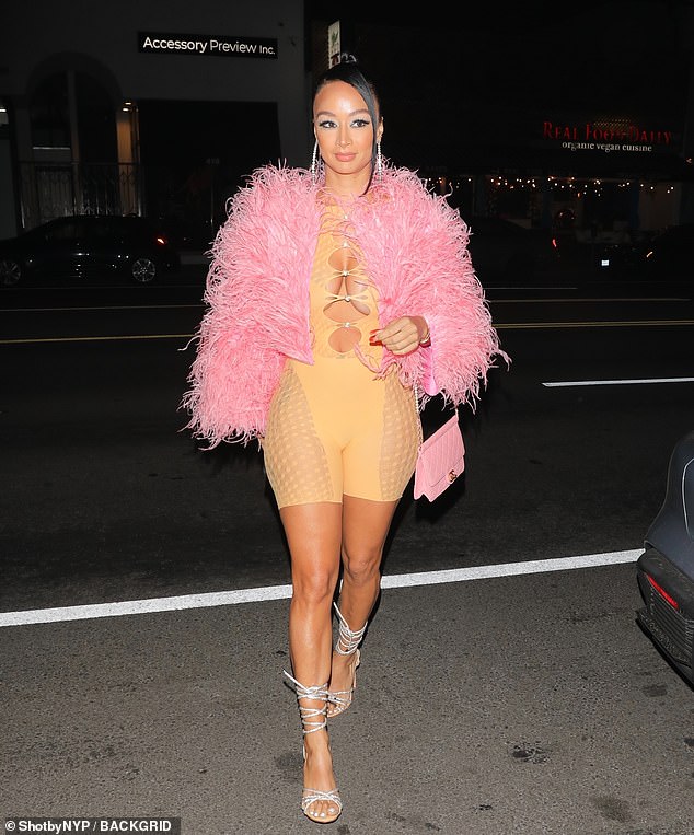 Draya Michele leaves little to the in a nude jumpsuit on a night out in West Hollywood