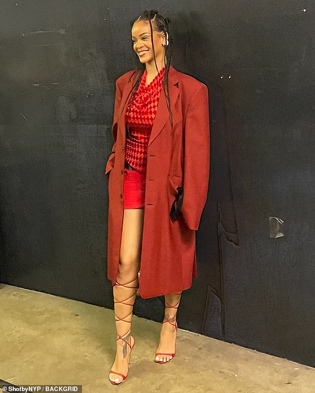 Rihanna is ravishing in all red including trench coat and mini skirt as she supports A$AP Rocky