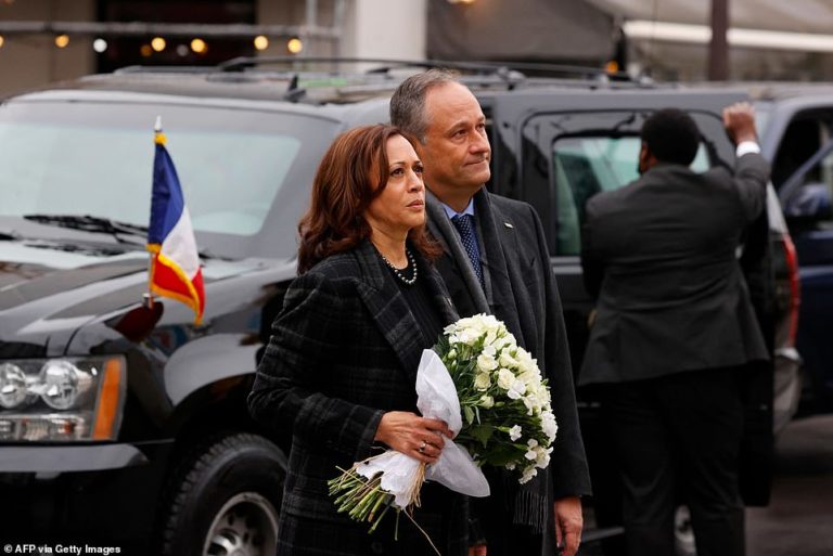 Kamala Harris and husband Douglas Emhoff stand at the scene of one of the 2015 Paris terror attacks