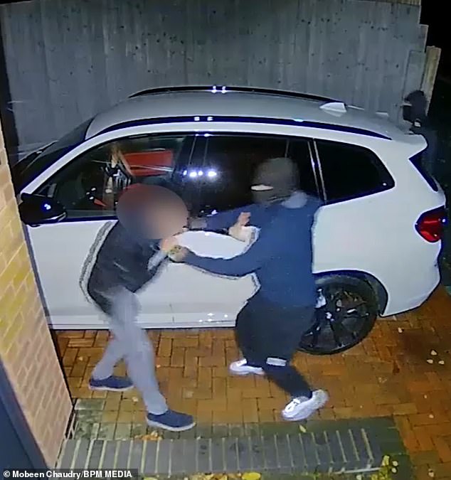 Driver tries to fight off masked carjackers as they steal his £85k BMW [VIDEO]