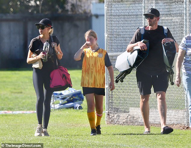 Newlyweds Tarek El Moussa and Heather Rae Young cheer on his daughter Taylor at her soccer match
