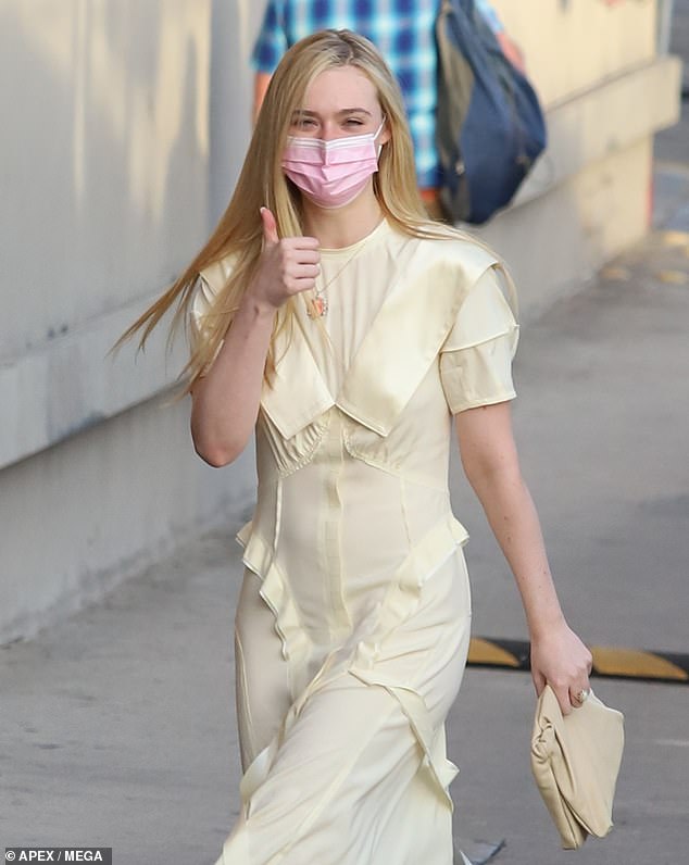 Elle Fanning sports a light look and gives a thumbs up to fans while heading into Jimmy Kimmel Live