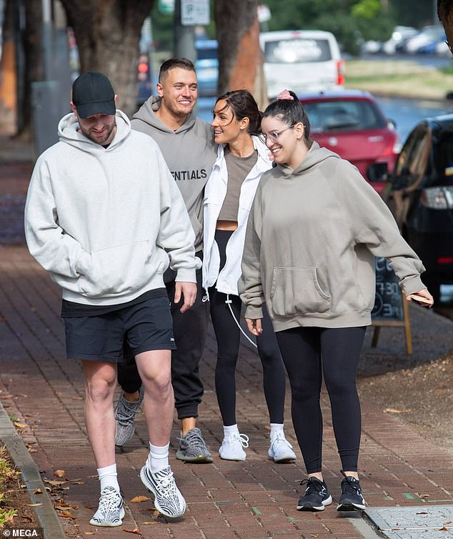 Kayla Itsines and boyfriend Jae Woodroffe stroll with her sister Leah and fiancé Mitch Caon