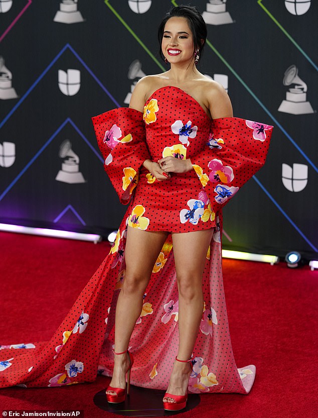 Becky G blooms in bright red floral print dress with short skirt and long train at Latin Grammys
