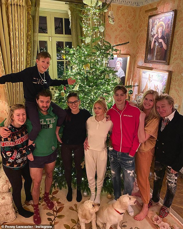 Rod Stewart, 76, poses with wife Penny Lancaster, 50, and four of his children in festive snap