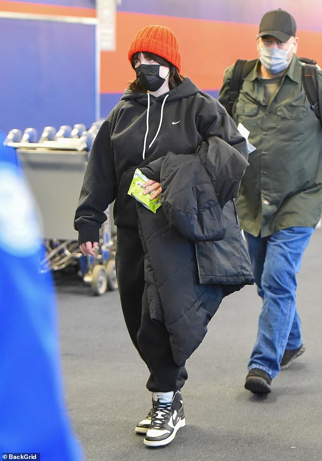 Billie Eilish sports black Nike sweats to catch flight out of JFK Airport in New York