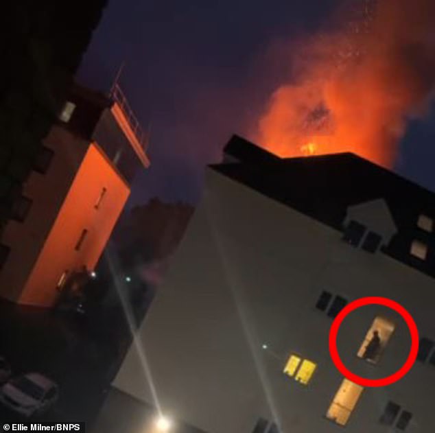 Terrifying video shows elderly man inside a block of retirement flats seemingly oblivious to fire