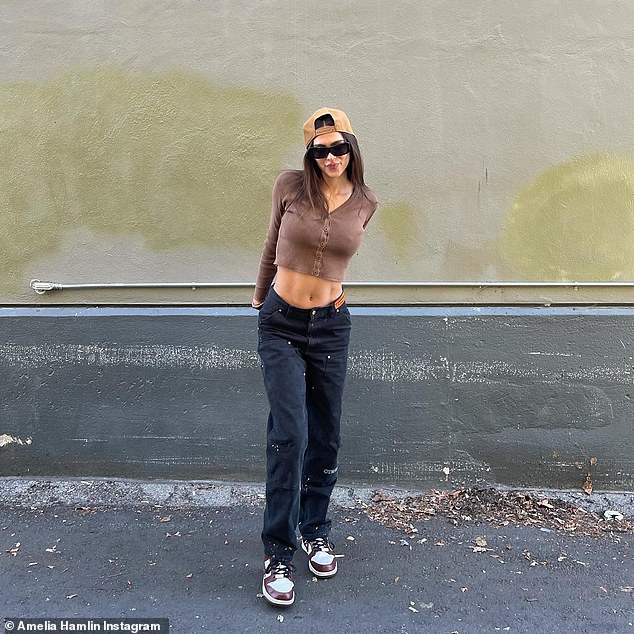 Amelia Hamlin flashes her taut tummy in a brown crop top and pens a mysterious caption