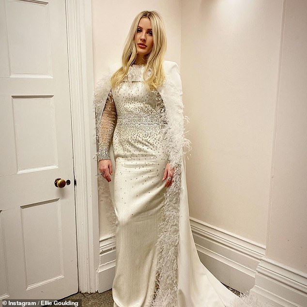 Ellie Goulding stuns in an incredible satin embellished gown and feathered cape