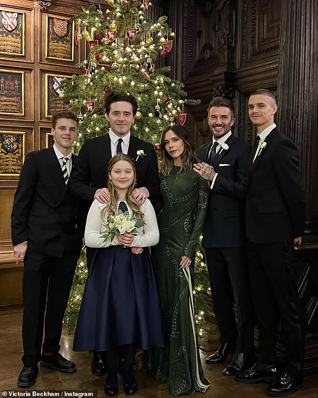 David Beckham amuses eagle-eyed fans as they spot him standing on his TIPTOES in festive snap