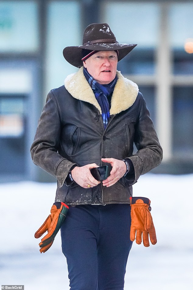 Conan O’Brien stays warm with a fur-lined coat and cowboy hat while walking the streets of Aspen