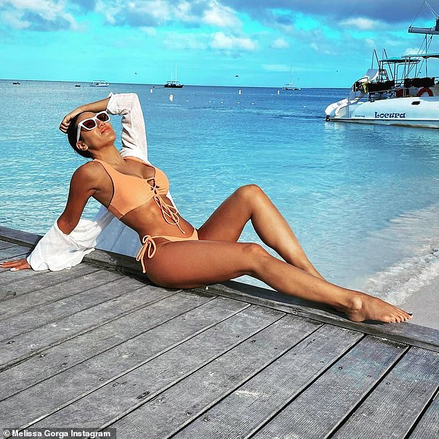Melissa Gorga stuns in an orange bikini as she gets ready to ring in the new year in Aruba