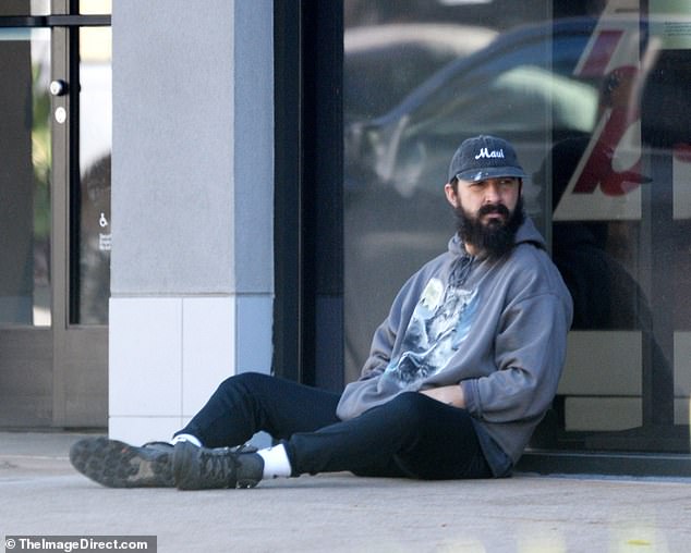 Shia LaBeouf sits on the sidewalk for his pregnant ex-wife Mia Goth as she heads into Pasadena store 1