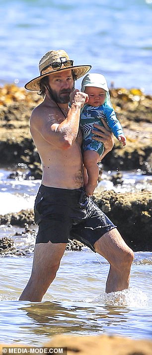 Joel Edgerton and Christine Centenera enjoy a day at the beach with their eight-month-old twins