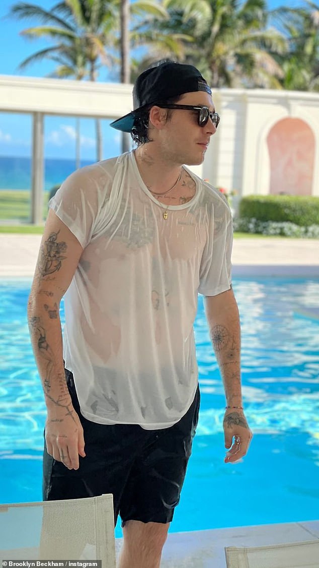 Brooklyn Beckham shows off her tattooed torso in a wet T-shirt by the pool in Miami 1
