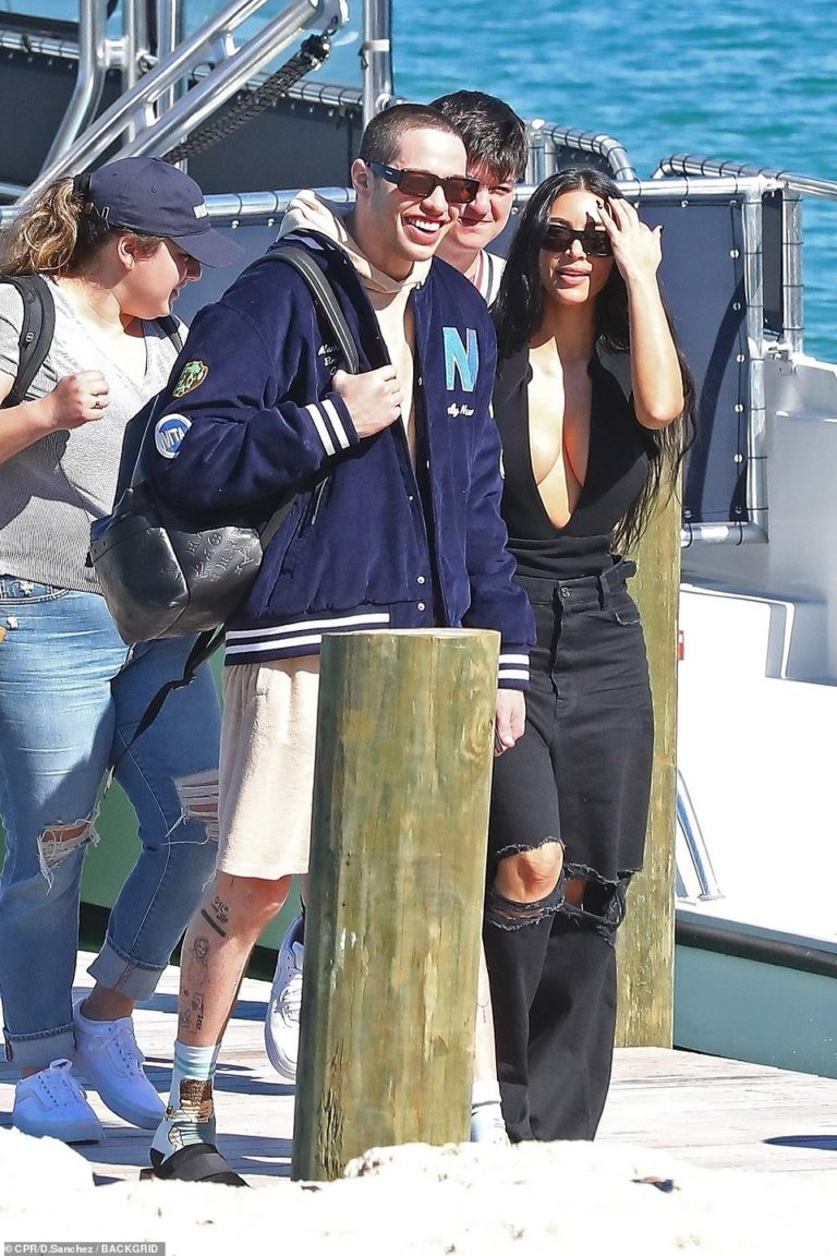 Kim Kardashian boards a boat with a beaming Pete Davidson during Bahamas getaway