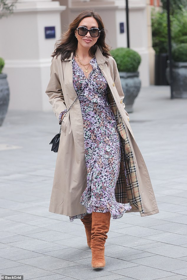 Myleene Klass looks effortlessly chic in a vintage floral dress and a classic trench coat