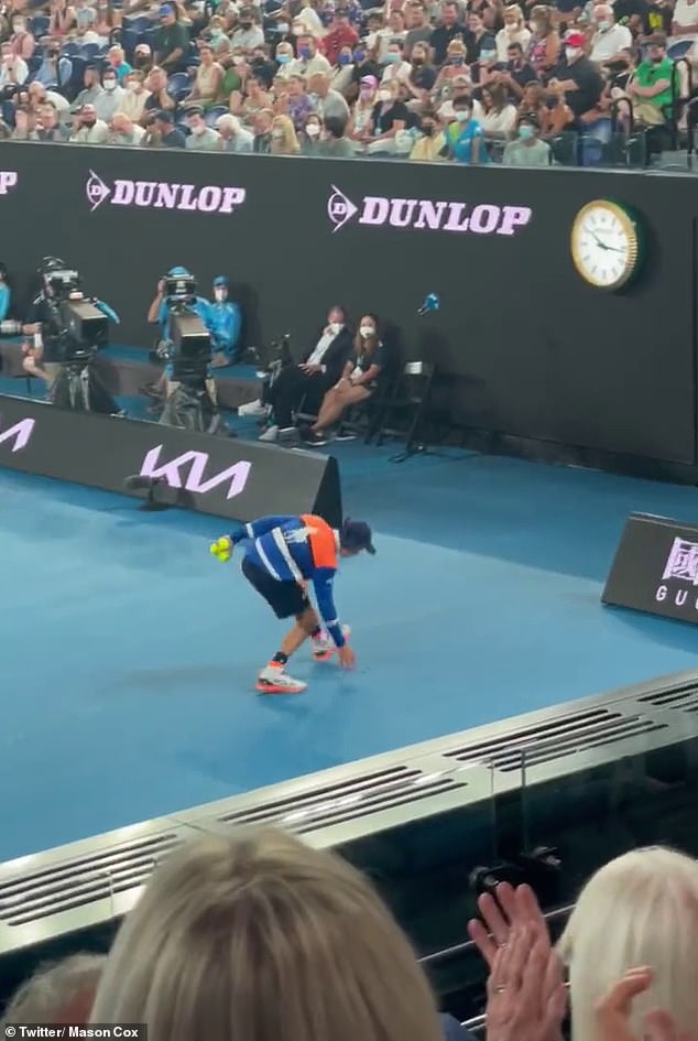 Adorable moment ball kid saves a cricket from getting squished on the court at the Australian Open  1