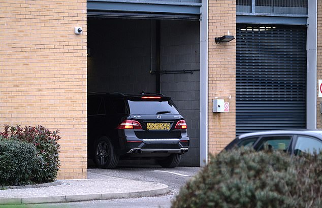 Katie Price is seen being driven away from West Sussex police station by boyfriend Carl Woods 