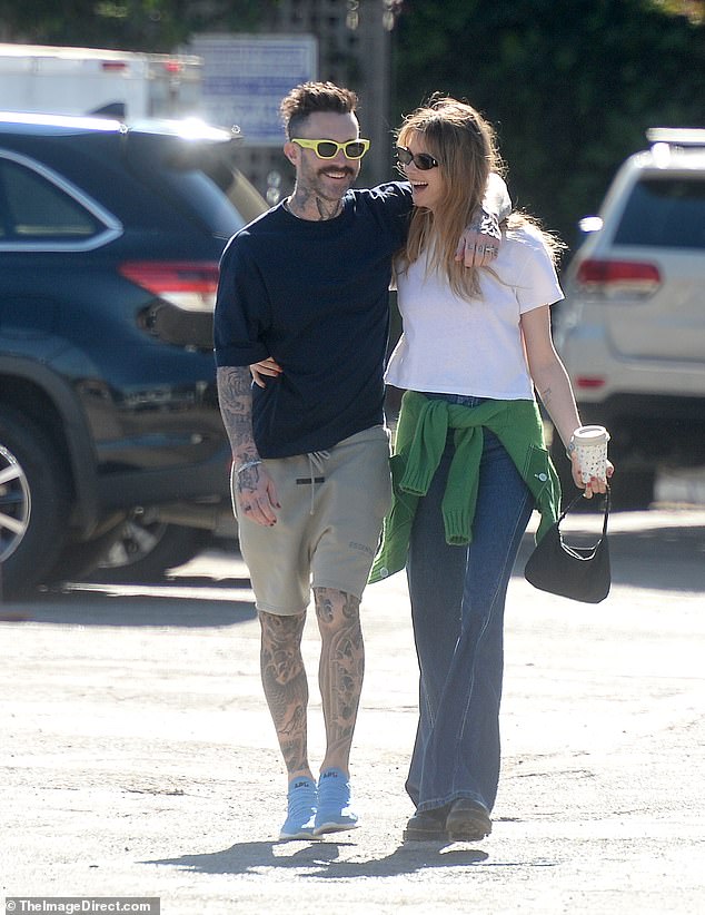 Adam Levine and wife Behati Prinsloo wrap arms around each other while out in Los Angeles