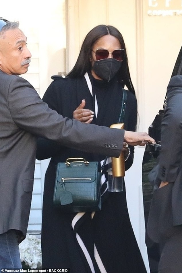 Naomi Campbell wears a chic duster as she exits LA skincare clinic wearing face mask and sunglasses