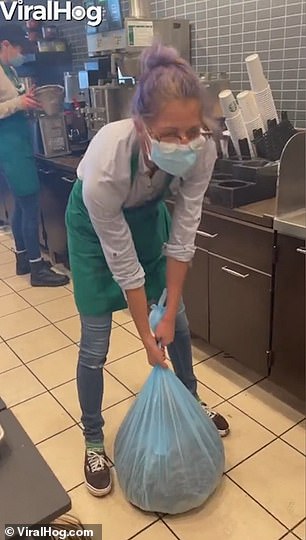 Starbucks barista topples over backwards as she throws sack of coffee over her shoulder [Video]