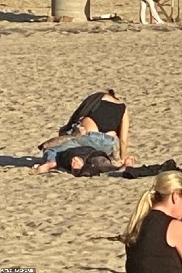 Kourtney Kardashian and Travis Barker romp around in the sand during hot and heavy make-out session