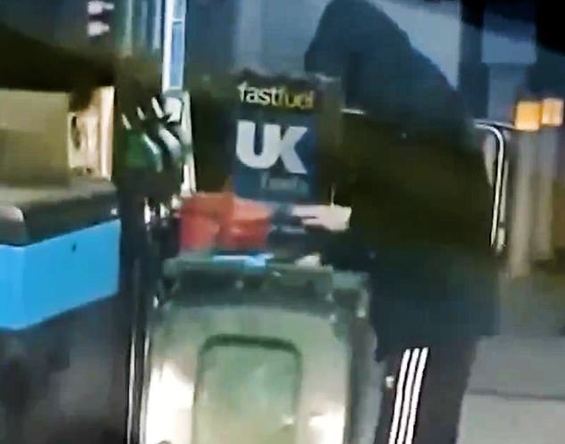 Thief fills up wheelie bin with fuel at busy petrol station forecourt