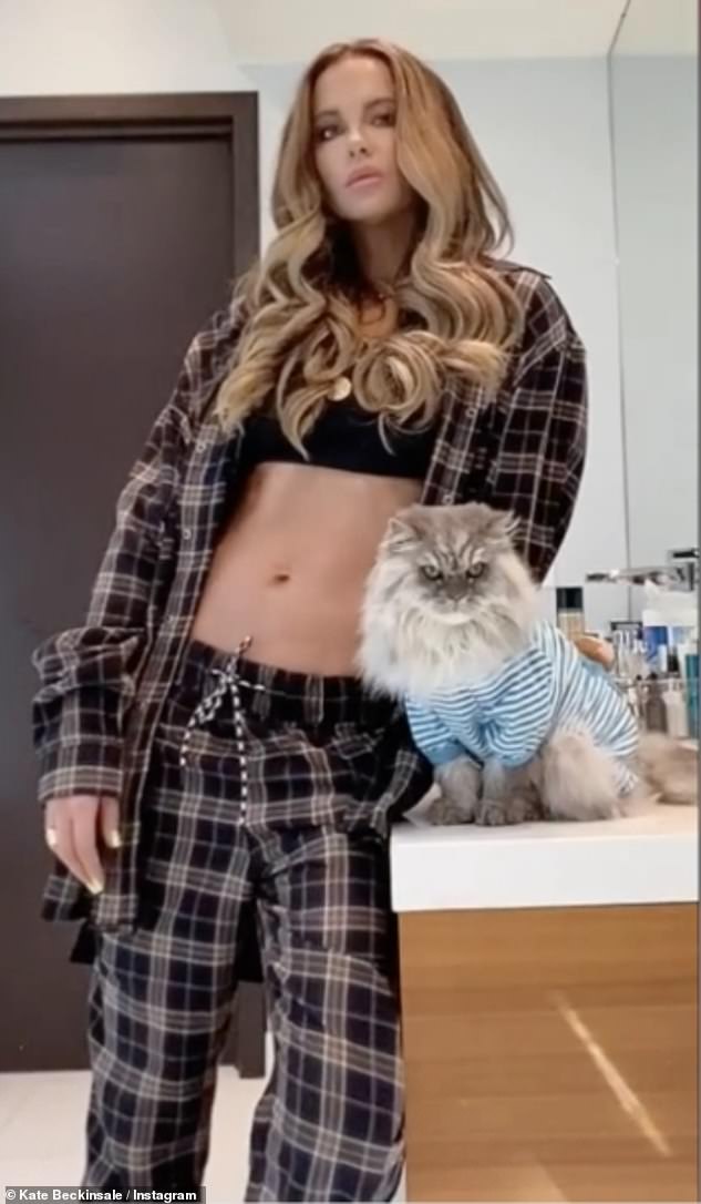Kate Beckinsale, 48, shows off toned abs in tartan pyjamas in video with cat Clive