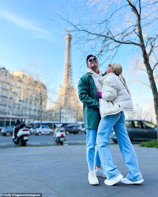 The Bachelor’s Jimmy Nicholson and Holly Kingston pose playfully in front of the Eiffel Tower